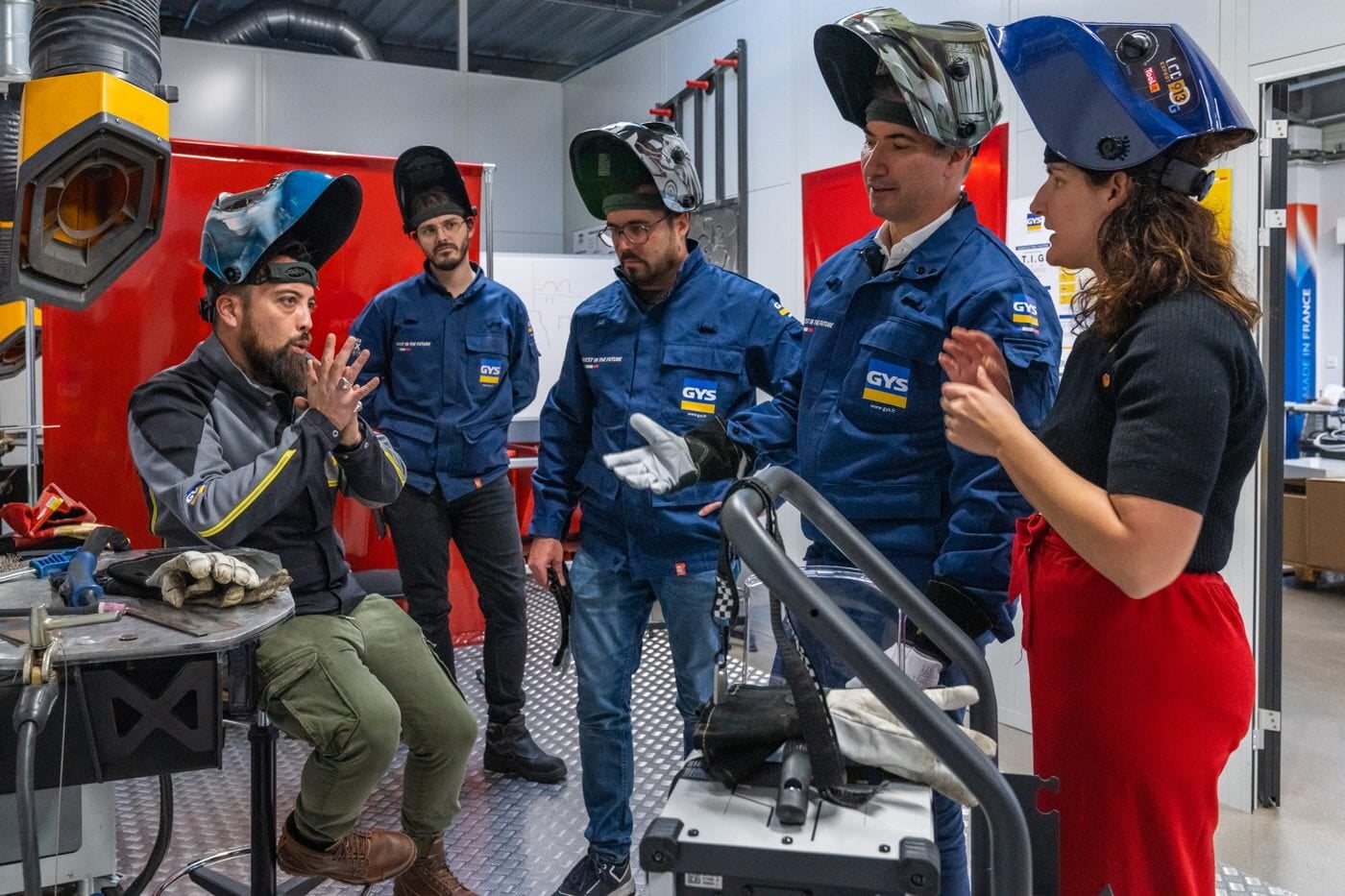 GYS trainees in welding helmets listening to an instructor